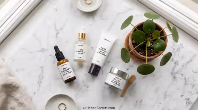 Essential anti-aging skincare products including retinol serum vitamin C serum and sunscreen on marble surface